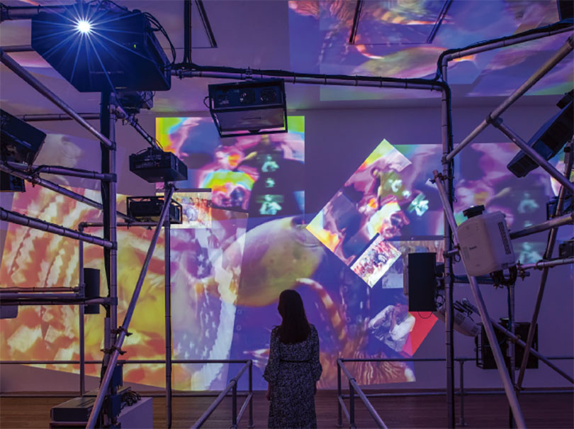Nam June Paik 〈Sistine Chapel〉 1993 Install view, Tate Modern 2019 Medium Video projectors, metal, wood, custom video switchers and four video channels, colour, sound Courtesy of the Estate of Nam June Paik