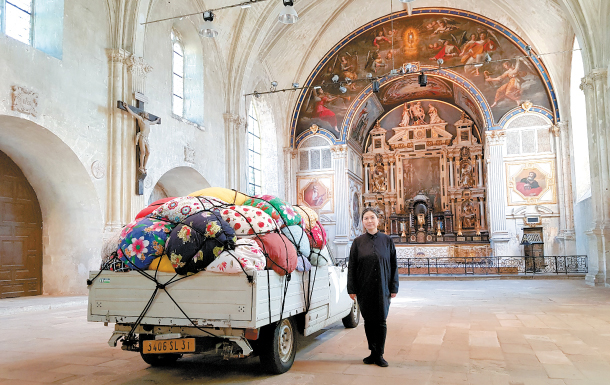 Artist Kimsooja stands with a truck used for her 2007 performance video “Bottari-Truck Migrateurs” inside Saint-Louis Chapel in Poitiers, France. The work is part of the initial edition of the French city’s new art festival “Traversees / Kimsooja.” MOON SO-YOUNG